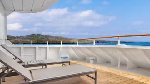 Deck with lounge chairs overlooking the ocean and islands - National Geographic Gemini, Lindblad Expeditions