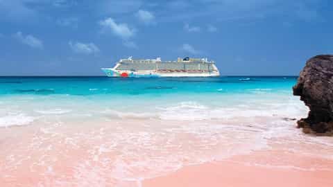 A cruise ship sails on the ocean near a pink sand beach - Norwegian Breakaway, Norwegian Cruise Line