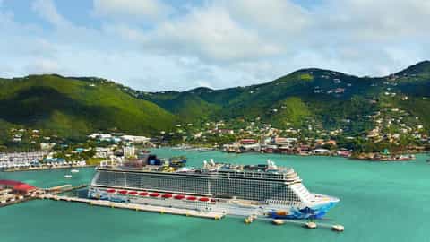 A large cruise ship is docked in a tropical port - Norwegian Escape, Norwegian Cruise Line