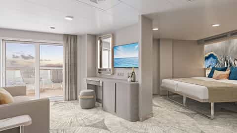 A suite with a bed, seating area, and balcony - Norwegian Prima, Norwegian Cruise Line