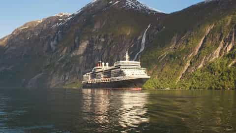 A large cruise ship sails through a Norwegian fjord - Queen Elizabeth, Cunard