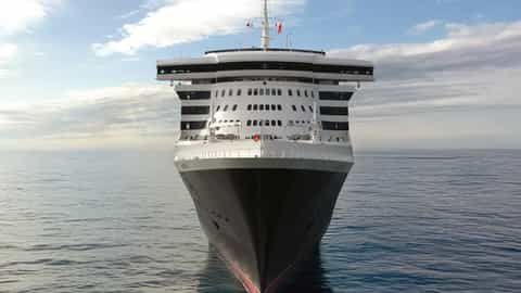 A large cruise ship is seen from the bow on the ocean - Queen Mary 2, Cunard