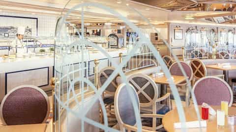 A buffet dining room with tables and chairs - Queen Victoria, Cunard