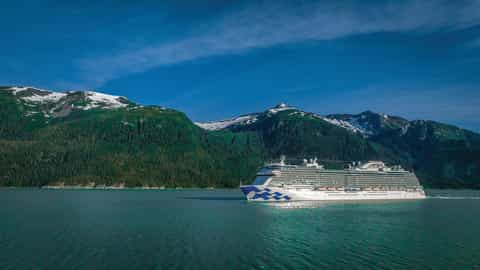 A large cruise ship sails past snow-capped mountains - Regal Princess, Princess Cruises
