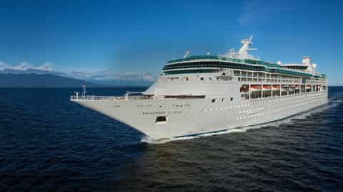 A large white cruise ship sails on the ocean - Rhapsody Of The Seas, Royal Caribbean