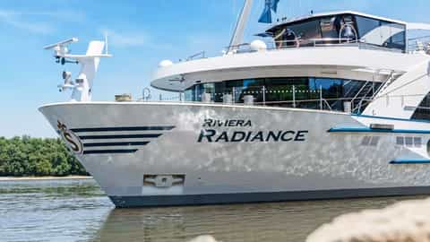 A white river boat with the name Riviera Radiance on its hull - Riviera Radiance, Riviera Travel
