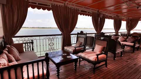 Outdoor lounge seating with a view of a wide river - RV Jahan, Lindblad Expeditions