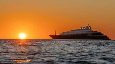 A large cruise ship sails on the ocean at sunset - Scenic Eclipse, Scenic Cruises