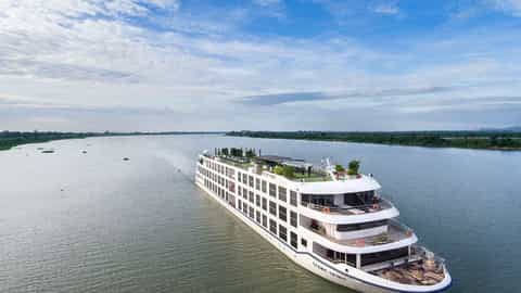 A white river cruise ship sails on a wide river - Scenic Spirit, Scenic Cruises