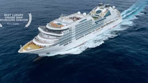 A large white luxury cruise ship sails through blue water - Seabourn Ovation, Seabourn Cruises
