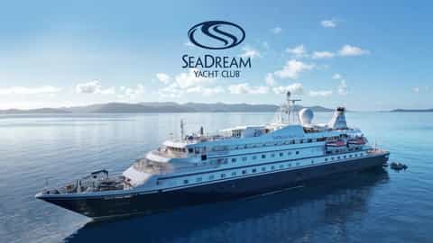 A yacht cruises on a calm blue sea under a clear sky - SeaDream I, SeaDream Yacht Club