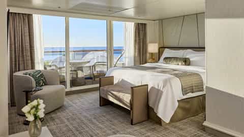A spacious suite bedroom with a balcony overlooking the sea - Seven Seas Mariner, Regent Seven Seas Cruises