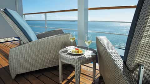Two chairs and a table with drinks on a balcony - Seven Seas Navigator, Regent Seven Seas Cruises
