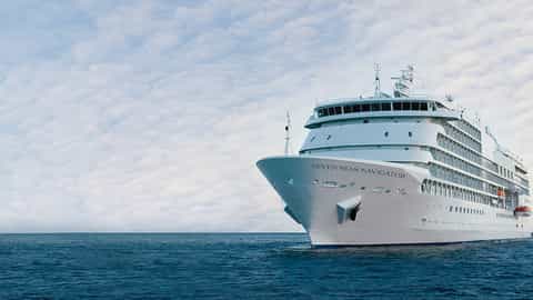 A large white cruise ship sails on the blue sea - Seven Seas Navigator, Regent Seven Seas Cruises