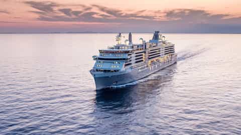 A large cruise ship sails on the ocean at sunset - Silver Cloud, Silversea Cruises