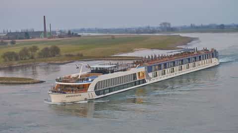 A river cruise ship sails on a wide river - AmaVenita, AmaWaterways