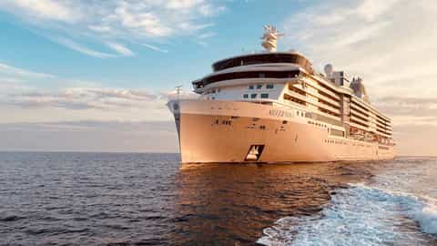 A large cruise ship sails on the ocean at sunset - Silver Nova, Silversea Cruises