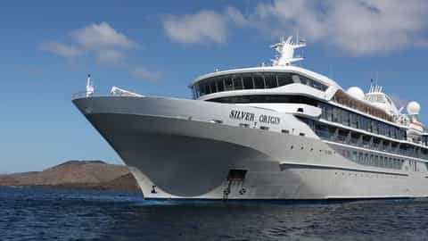 A large white ship sails on blue water - Silver Origin, Silversea Cruises
