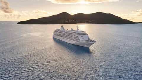 A large white cruise ship sails on calm water - Silver Whisper, Silversea Cruises