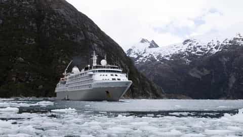 A cruise ship sails through icy waters near mountains - Silver Wind, Silversea Cruises