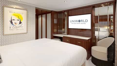 A river cruise suite bedroom with a bed and chair - SS Marlene, Uniworld