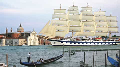 A tall ship sails past Venice with gondolas in the foreground - Star Clipper, Star Clippers