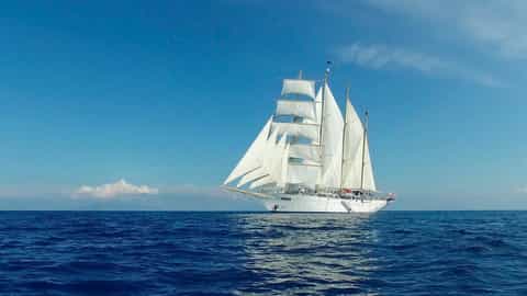 A white sailing ship with full sails on the ocean - Star Flyer, Star Clippers