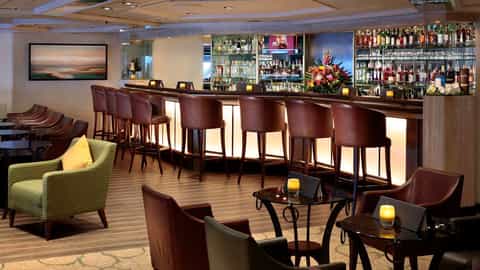 A bar with stools and lounge seating is shown - Star Pride, Windstar Cruises