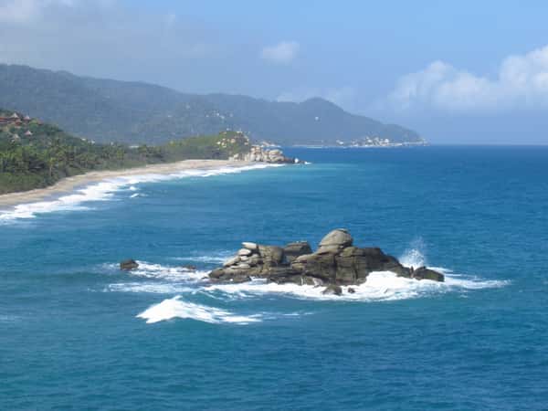 coastline beach ocean mountains