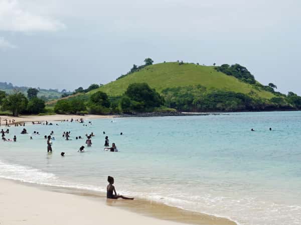 beach coastline hill ocean people swimming