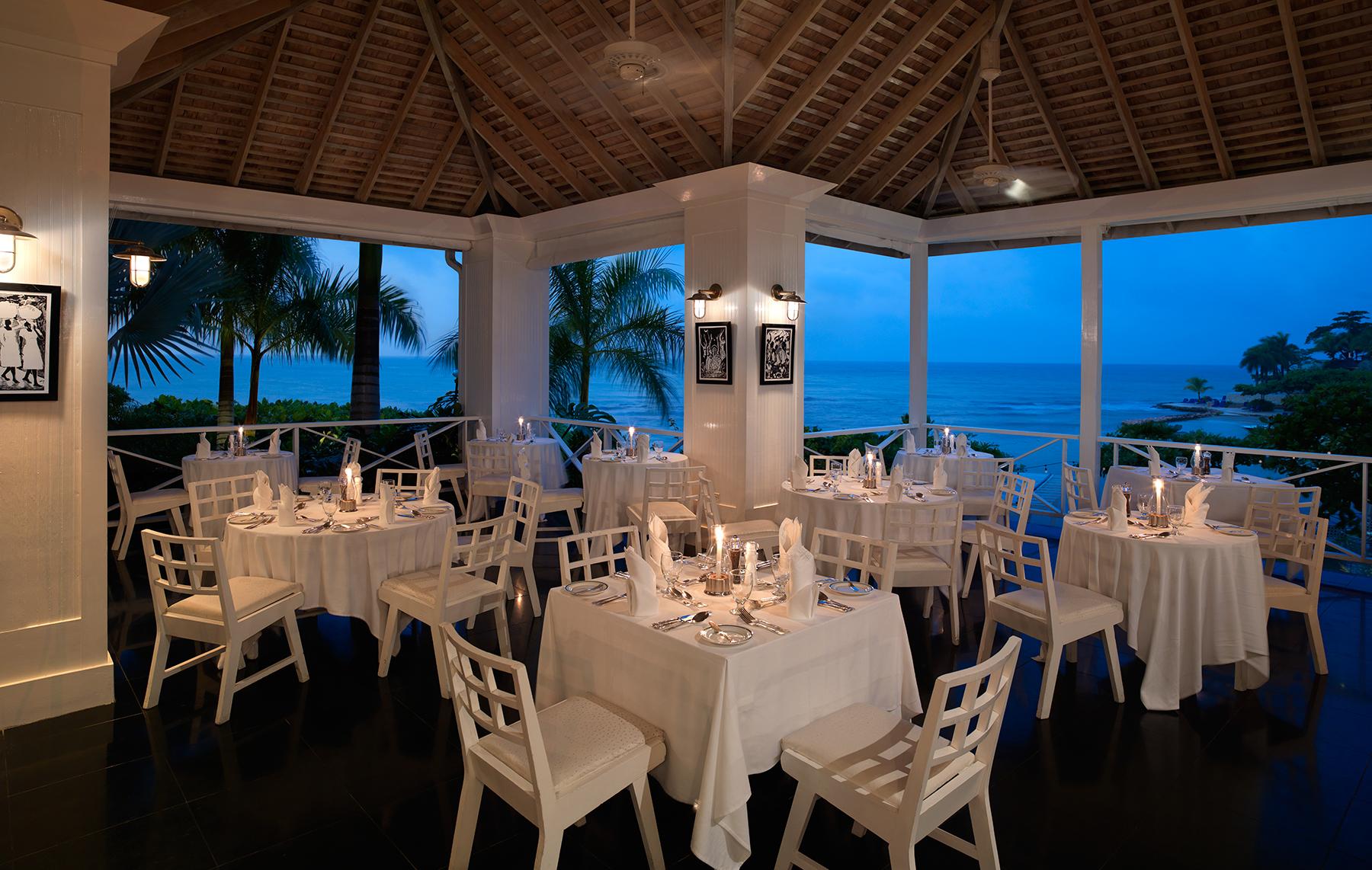 Round Hill Hotel and Villas, Jamaica — Round Hill Hotel and Villas - The Grill is our rooftop restaurant located above the bar and terrace, offering panoramic, seaside views and ocean breezes. The décor is in keeping with our classic aesthetic of relaxed